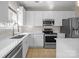 Bright kitchen features white cabinetry, stainless steel appliances, and quartz countertops at 604 Atherton Way, Rock Hill, SC 29730