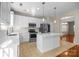 Bright kitchen with white cabinets, quartz countertops, stainless appliances and center island at 604 Atherton Way, Rock Hill, SC 29730