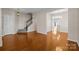 Open-concept living room with hardwood floors, staircase, and view into dining area at 604 Atherton Way, Rock Hill, SC 29730