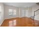 Spacious living room featuring hardwood floors, two entry doors and a staircase at 604 Atherton Way, Rock Hill, SC 29730