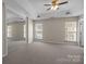 The large main bedroom features a ceiling fan, three windows and neutral carpet at 604 Atherton Way, Rock Hill, SC 29730