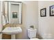 This powder room features pedestal sink and decorative wall art at 6301 Raven Rock Dr, Denver, NC 28037