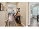 Elegant entryway with hardwood floors, a decorative console table, and a view into the living spaces at 6301 Raven Rock Dr, Denver, NC 28037