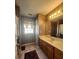 Traditional bathroom featuring wood vanity with white countertops and a large mirror at 7135 Tabor Falls Dr, Harrisburg, NC 28075