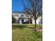 Charming two-story home featuring a two-car garage, well-manicured lawn and traditional architectural design at 7135 Tabor Falls Dr, Harrisburg, NC 28075