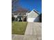 Charming two-story home featuring a two-car garage, well-manicured lawn and traditional architectural design at 7135 Tabor Falls Dr, Harrisburg, NC 28075