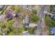 Aerial view of homes in a wooded neighborhood showing driveways and mature trees at 7201 Brassy Creek Ln, Charlotte, NC 28269