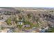 Expansive aerial view of a neighborhood, featuring mature trees and residences with backyard pools at 7201 Brassy Creek Ln, Charlotte, NC 28269