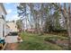 Exterior backyard with mature trees and lawn, and exterior patio at 7201 Brassy Creek Ln, Charlotte, NC 28269