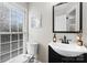 Half bathroom with black vanity, toilet and large window at 7201 Brassy Creek Ln, Charlotte, NC 28269