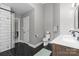 Bathroom with a double sink vanity, a shower with a glass door, and a toilet at 7201 Brassy Creek Ln, Charlotte, NC 28269