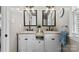 Bathroom featuring a double sink vanity, two mirrors, and modern lighting at 7201 Brassy Creek Ln, Charlotte, NC 28269