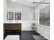 Bathroom with a double sink vanity, a large mirror, and walk-in shower with modern black trim at 7201 Brassy Creek Ln, Charlotte, NC 28269