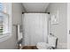 Bathroom with neutral walls, a toilet, and a shower with a patterned curtain at 7201 Brassy Creek Ln, Charlotte, NC 28269