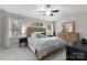 Bright bedroom featuring a vaulted ceiling, ceiling fan, and natural wood furniture set at 7201 Brassy Creek Ln, Charlotte, NC 28269