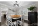 Elegant dining room featuring a stylish light fixture and a large window with natural light at 7201 Brassy Creek Ln, Charlotte, NC 28269