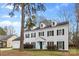 Charming traditional home with a vibrant turquoise door, dormer windows, and manicured landscaping at 7201 Brassy Creek Ln, Charlotte, NC 28269
