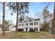 Inviting traditional home with a two-car garage, dormer windows, and a pristine white exterior at 7201 Brassy Creek Ln, Charlotte, NC 28269