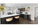 Well-appointed kitchen with an island, wine fridge, and stylish bar stools at 7201 Brassy Creek Ln, Charlotte, NC 28269