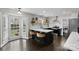 Bright kitchen with island, white counters, subway tile backsplash, and open shelving at 7201 Brassy Creek Ln, Charlotte, NC 28269