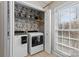 Convenient laundry room with shelving and natural light from the window at 7201 Brassy Creek Ln, Charlotte, NC 28269