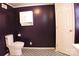 Updated bathroom featuring a toilet, vanity, and black and white patterned flooring at 802 Lewis St, Gastonia, NC 28054