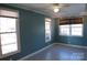 Bright bedroom features modern patterned floors, three windows, and natural light at 802 Lewis St, Gastonia, NC 28054