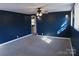Bedroom with neutral carpet, blue accent wall, and updated lighting at 802 Lewis St, Gastonia, NC 28054