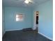 Light blue bedroom featuring a ceiling fan and two windows at 802 Lewis St, Gastonia, NC 28054