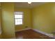 Bright bedroom with yellow walls, hardwood floors, and a window offering natural light at 802 Lewis St, Gastonia, NC 28054