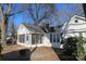 Cozy home featuring a screened porch, white siding, and a welcoming outdoor patio area perfect for entertaining at 802 Lewis St, Gastonia, NC 28054
