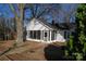 Charming home featuring a screened-in porch, surrounded by mature trees and lush landscaping at 802 Lewis St, Gastonia, NC 28054