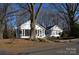 Charming home with screened-in porch and mature trees lining the property at 802 Lewis St, Gastonia, NC 28054