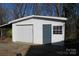 Exterior shot of a detached garage with a door and window, offering convenient parking at 802 Lewis St, Gastonia, NC 28054