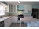 Bright kitchen featuring stainless steel appliances, white cabinets and an island at 802 Lewis St, Gastonia, NC 28054