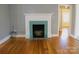 Bright living room featuring a decorative fireplace and hardwood flooring at 802 Lewis St, Gastonia, NC 28054