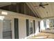 Covered porch boasting a ceiling fan and plenty of natural light through the windows at 802 Lewis St, Gastonia, NC 28054