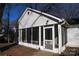 Detailed view of home's inviting screened porch with white trim and easy access front door at 802 Lewis St, Gastonia, NC 28054