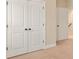 Bedroom closet featuring double doors with dark hardware and neutral colored walls and carpet at 83202 Cortland Dr, Lancaster, SC 29720