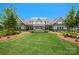 Beautiful clubhouse exterior with manicured lawn and landscaping, enhancing community appeal at 83202 Cortland Dr, Lancaster, SC 29720