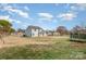 Spacious backyard with a large grassy area, a trampoline, and a fenced perimeter at 8552 Indian Summer Trl, Harrisburg, NC 28075