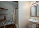 Accessible bathroom featuring open shelving, shower seat, and a sleek pedestal sink at 8749 Dog Leg Rd # 7, Sherrills Ford, NC 28673