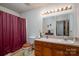 Bathroom featuring a single sink vanity and shower with a maroon curtain at 8749 Dog Leg Rd # 7, Sherrills Ford, NC 28673