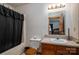 Bathroom featuring a wooden vanity, toilet and shower/tub with a black shower curtain at 8749 Dog Leg Rd # 7, Sherrills Ford, NC 28673