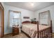 Cozy bedroom with wood-frame bed, bedside tables, and bright windows for ample natural light at 8749 Dog Leg Rd # 7, Sherrills Ford, NC 28673