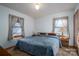 Bedroom featuring neutral paint, carpet and two windows with charming paisley bedding at 8749 Dog Leg Rd # 7, Sherrills Ford, NC 28673