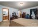 Bedroom with en suite bath, complemented by natural light and furnishings with carpeted floors at 8749 Dog Leg Rd # 7, Sherrills Ford, NC 28673
