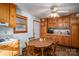 Eat-in kitchen with wood cabinets, white appliances, and a ceiling fan at 8749 Dog Leg Rd # 7, Sherrills Ford, NC 28673