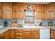 Kitchen with wooden cabinets, a window over the sink, and light colored countertops at 8749 Dog Leg Rd # 7, Sherrills Ford, NC 28673