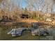 View of the lake with a wooden pier and the house visible in the background at 8749 Dog Leg Rd # 7, Sherrills Ford, NC 28673
